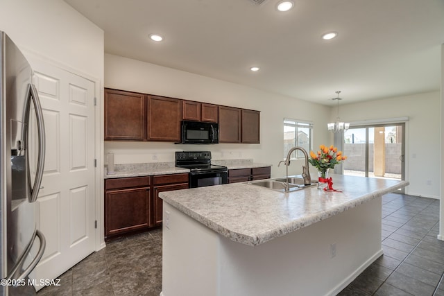 8045 S Red Sox Rd, Tucson, AZ 85756 - kitchen with black appliances, a sink, light countertops, decorative light fixtures, and recessed lighting