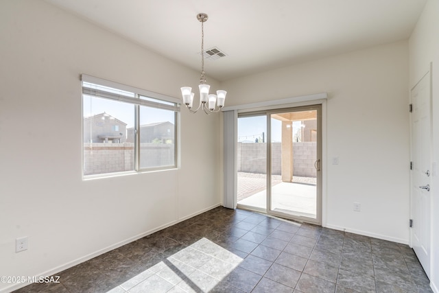 8045 S Red Sox Rd, Tucson, AZ 85756 - tiled empty room featuring plenty of natural light, a chandelier, and baseboards
