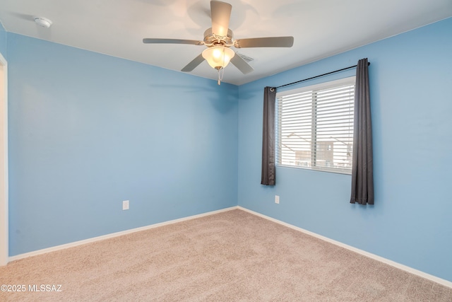 8045 S Red Sox Rd, Tucson, AZ 85756 - spare room featuring carpet, baseboards, a smoke detector, and a ceiling fan