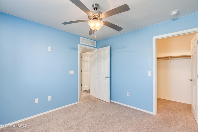 8045 S Red Sox Rd, Tucson, AZ 85756 - unfurnished bedroom with carpet, a walk in closet, baseboards, and a closet