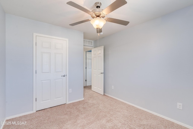 8045 S Red Sox Rd, Tucson, AZ 85756 - unfurnished bedroom featuring carpet, baseboards, and a ceiling fan