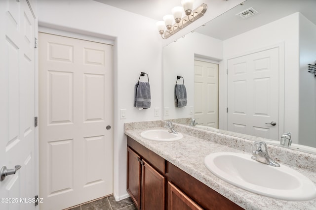 8045 S Red Sox Rd, Tucson, AZ 85756 - full bathroom with double vanity, baseboards, and tile patterned floors