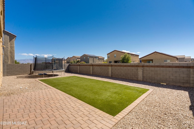 8045 S Red Sox Rd, Tucson, AZ 85756 - view of yard featuring a trampoline, a patio, and a residential view