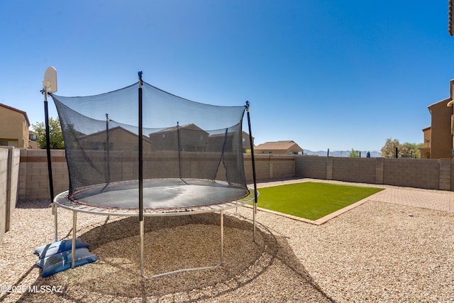 8045 S Red Sox Rd, Tucson, AZ 85756 - fenced backyard featuring a trampoline