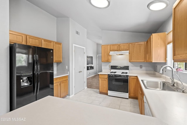 8807 S Desert Rainbow Dr, Tucson, AZ 85747 - kitchen featuring gas range, black refrigerator with ice dispenser, a sink, lofted ceiling, and under cabinet range hood
