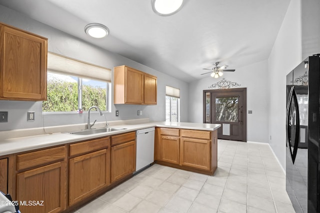 8807 S Desert Rainbow Dr, Tucson, AZ 85747 - kitchen featuring dishwasher, freestanding refrigerator, a sink, a peninsula, and plenty of natural light