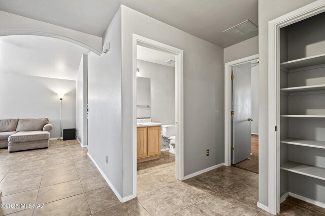 8807 S Desert Rainbow Dr, Tucson, AZ 85747 - corridor with light tile patterned flooring and baseboards