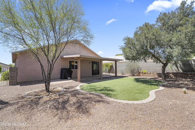 8807 S Desert Rainbow Dr, Tucson, AZ 85747 - rear view of property with stucco siding and a patio area