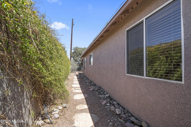8807 S Desert Rainbow Dr, Tucson, AZ 85747 - view of side of home featuring stucco siding