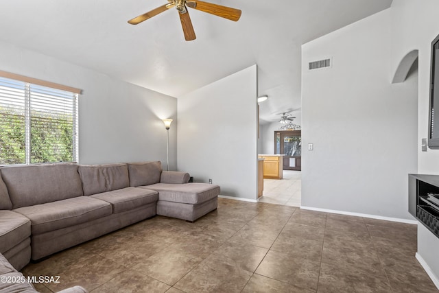 8807 S Desert Rainbow Dr, Tucson, AZ 85747 - living room with a ceiling fan, vaulted ceiling, and baseboards