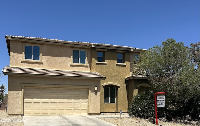 1027 E Madera Grove Ln, Sahuarita, AZ 85629 - view of front of home with driveway, stucco siding, and a garage