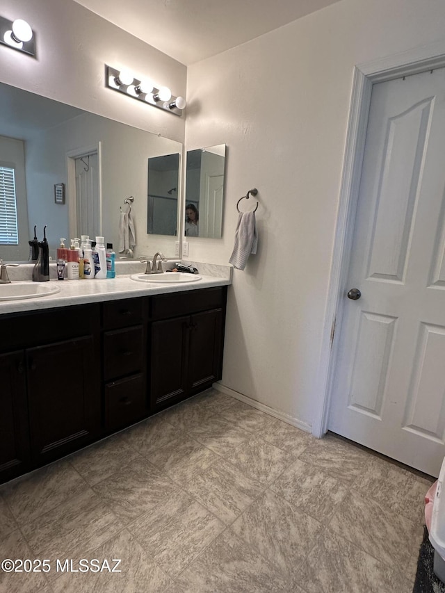 1027 E Madera Grove Ln, Sahuarita, AZ 85629 - bathroom with double vanity and baseboards