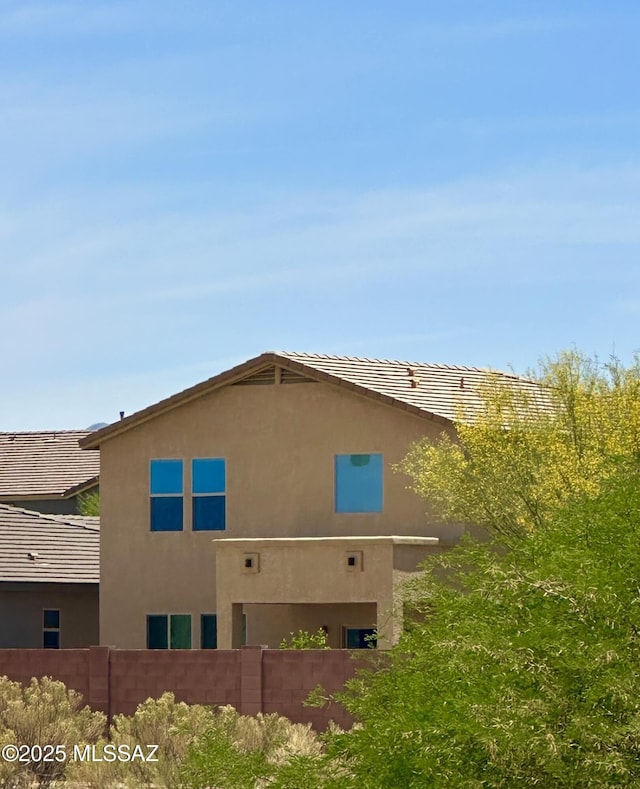 1027 E Madera Grove Ln, Sahuarita, AZ 85629 - view of property exterior featuring stucco siding and fence