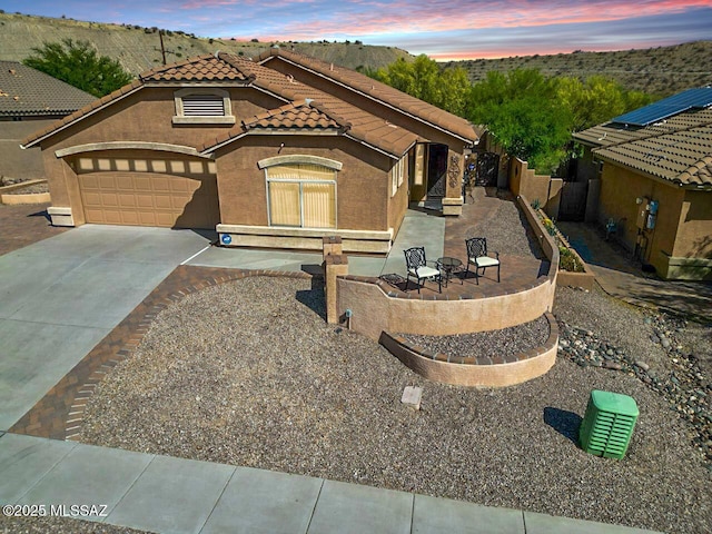 710 W Rio Teras, Green Valley, AZ 85614 - view of front of home with concrete driveway, a tile roof, an attached garage, stucco siding, and fence