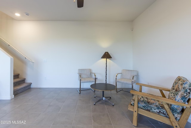 1126 E Cairn St, Tucson, AZ 85719 - sitting room with stairway, light tile patterned floors, ceiling fan, and baseboards