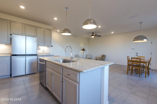 1126 E Cairn St, Tucson, AZ 85719 - kitchen with appliances with stainless steel finishes, a sink, light tile patterned floors, a ceiling fan, and recessed lighting