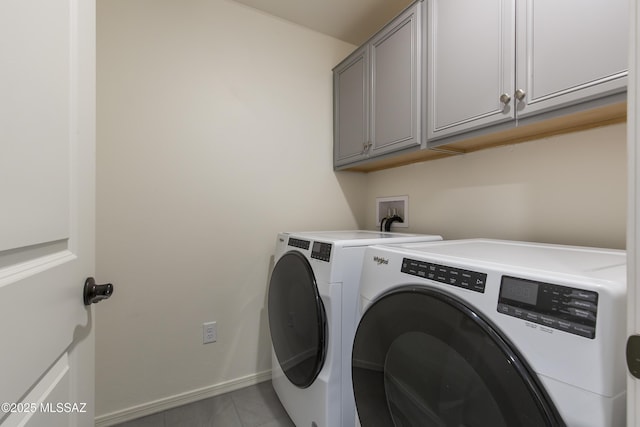 1126 E Cairn St, Tucson, AZ 85719 - laundry room with cabinet space, separate washer and dryer, light tile patterned floors, and baseboards