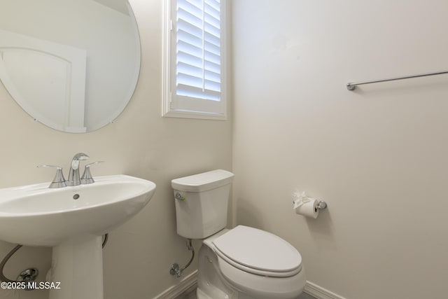 1126 E Cairn St, Tucson, AZ 85719 - bathroom with baseboards, toilet, and a sink