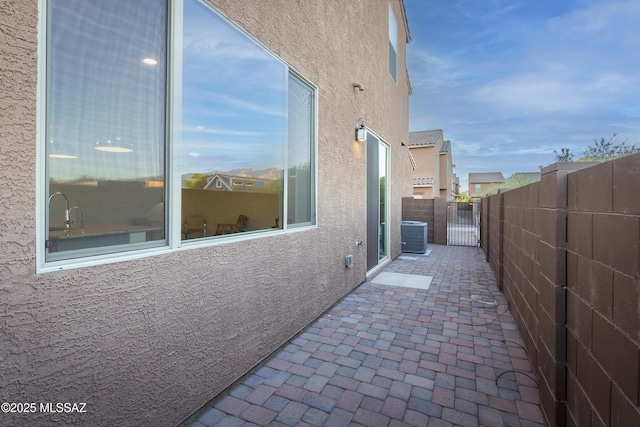 1126 E Cairn St, Tucson, AZ 85719 - view of side of property with stucco siding, fence, a patio, and central air condition unit