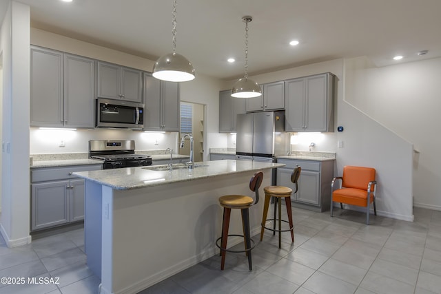1126 E Cairn St, Tucson, AZ 85719 - kitchen with stainless steel appliances, a sink, gray cabinets, a center island with sink, and recessed lighting