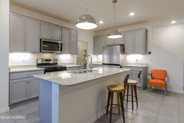1126 E Cairn St, Tucson, AZ 85719 - kitchen with stainless steel appliances, gray cabinetry, a sink, light tile patterned floors, and recessed lighting