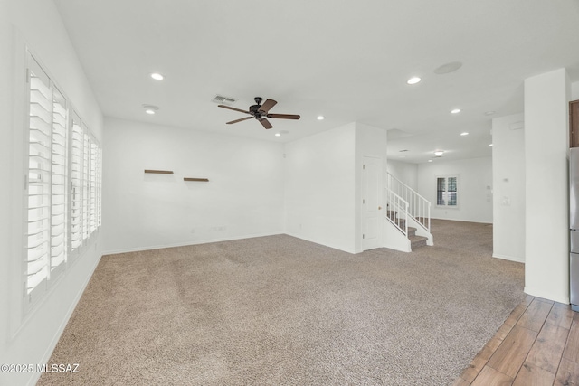 empty room with recessed lighting, stairs, ceiling fan, wood finished floors, and baseboards