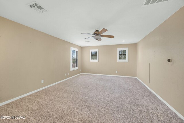 unfurnished room featuring a ceiling fan, carpet flooring, and baseboards
