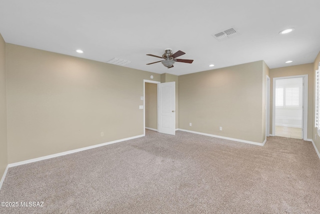 carpeted spare room featuring ceiling fan, baseboards, and recessed lighting