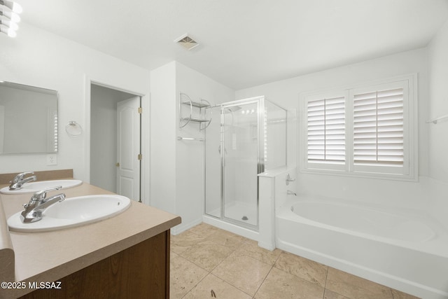 bathroom with a shower stall, a bath, double vanity, and tile patterned flooring