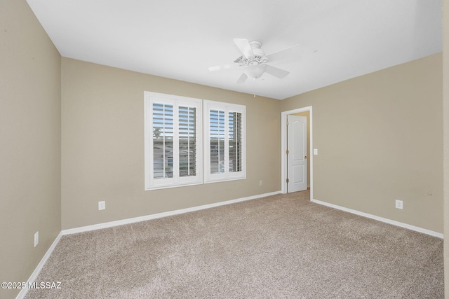unfurnished room featuring carpet floors, ceiling fan, and baseboards