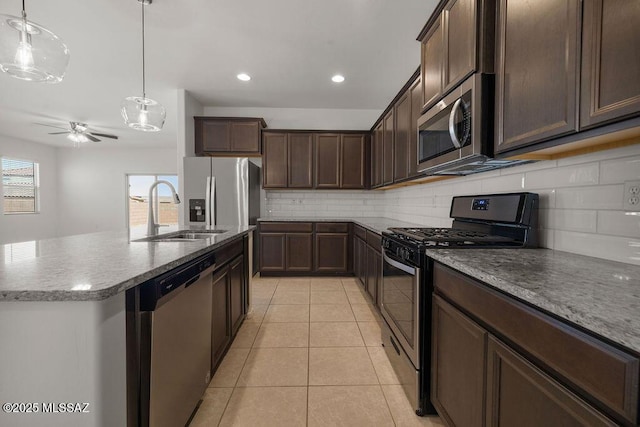 14259 E Yellow Sage Ln, Vail, AZ 85641 - kitchen with appliances with stainless steel finishes, a sink, ceiling fan, tasteful backsplash, and dark brown cabinets