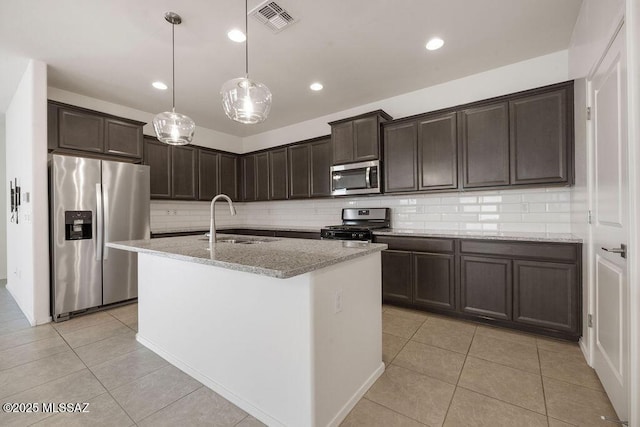 14259 E Yellow Sage Ln, Vail, AZ 85641 - kitchen with appliances with stainless steel finishes, a sink, backsplash, dark brown cabinets, and light tile patterned floors