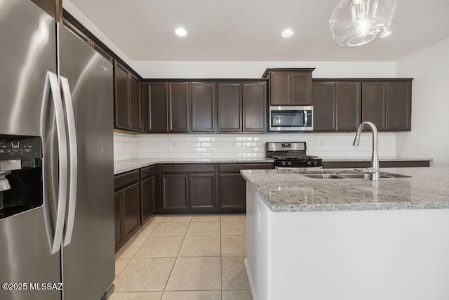 14259 E Yellow Sage Ln, Vail, AZ 85641 - kitchen with stainless steel appliances, a sink, backsplash, dark brown cabinets, and recessed lighting