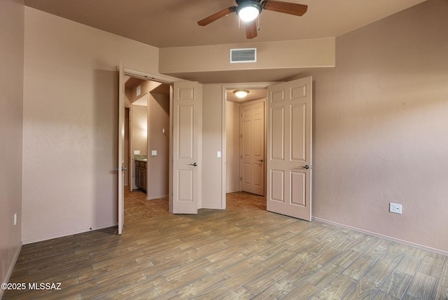 110 Post Way, Tubac, AZ 85646 - unfurnished bedroom with wood finished floors and a ceiling fan