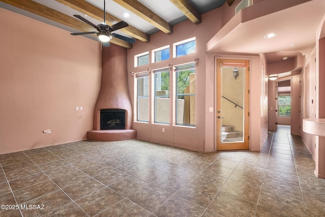 110 Post Way, Tubac, AZ 85646 - unfurnished living room with a ceiling fan, beamed ceiling, baseboards, a towering ceiling, and recessed lighting