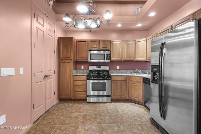 110 Post Way, Tubac, AZ 85646 - kitchen featuring stainless steel appliances, recessed lighting, brown cabinetry, a sink, and light stone counters