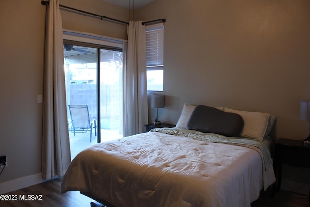 7747 S Lions Spring Way, Tucson, AZ 85747 - bedroom with access to outside, wood finished floors, and baseboards