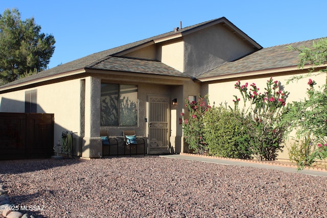 7747 S Lions Spring Way, Tucson, AZ 85747 - view of front of house with stucco siding and roof with shingles