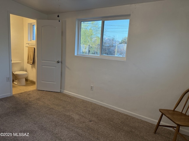4910 N Gold Ave, Tucson, AZ 85705 - bedroom with carpet floors, baseboards, and connected bathroom