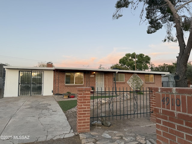 4910 N Gold Ave, Tucson, AZ 85705 - ranch-style house featuring a fenced front yard, brick siding, and a chimney