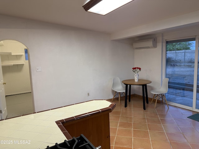 4910 N Gold Ave, Tucson, AZ 85705 - tiled dining area with an AC wall unit and arched walkways