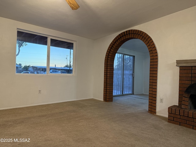 4910 N Gold Ave, Tucson, AZ 85705 - carpeted empty room featuring baseboards and arched walkways