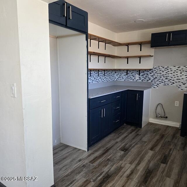 5850 E Lee St, Tucson, AZ 85712 - kitchen featuring dark wood-style floors, tasteful backsplash, blue cabinets, and light countertops