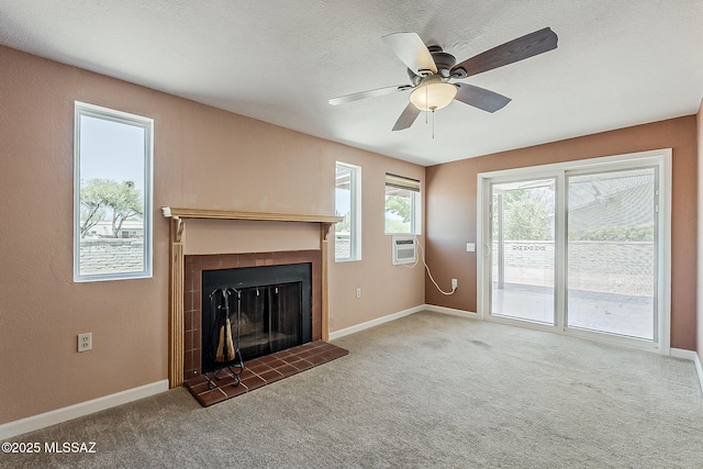 140 W Calle Melendrez, Green Valley, AZ 85614 - unfurnished living room featuring carpet flooring, a tiled fireplace, a ceiling fan, and baseboards