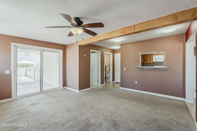 140 W Calle Melendrez, Green Valley, AZ 85614 - unfurnished living room featuring baseboards, ceiling fan, carpet flooring, and a textured ceiling