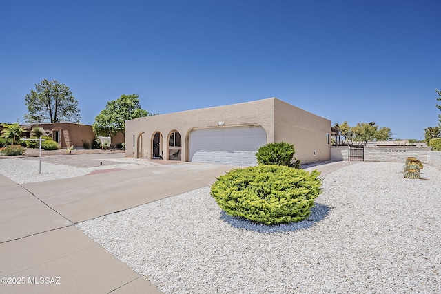 140 W Calle Melendrez, Green Valley, AZ 85614 - view of front facade with a gate, an attached garage, stucco siding, and concrete driveway