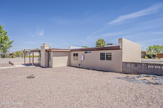 140 W Calle Melendrez, Green Valley, AZ 85614 - rear view of house with stucco siding, a patio area, and a chimney