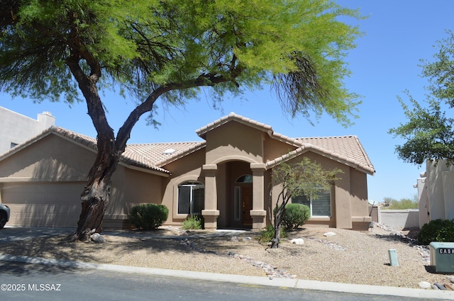 1645 E Ganymede Dr, Tucson, AZ 85737 - view of front of property with an attached garage, stucco siding, a tiled roof, and driveway