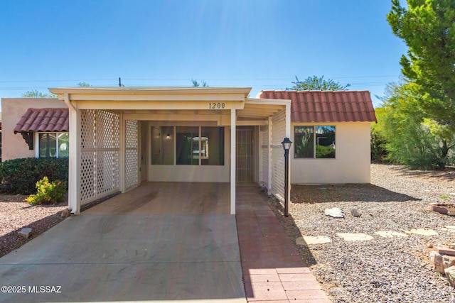 1200 S Alpine Cir, Green Valley, AZ 85614 - view of front of property featuring stucco siding, a carport, and driveway