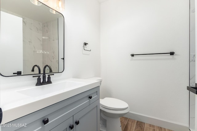 1200 S Alpine Cir, Green Valley, AZ 85614 - full bathroom featuring vanity, toilet, wood finished floors, and baseboards
